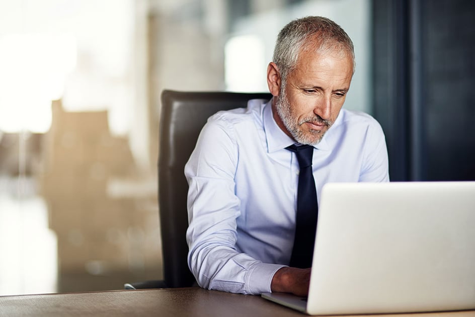 Man at computer | Buying into a QSR franchise concept