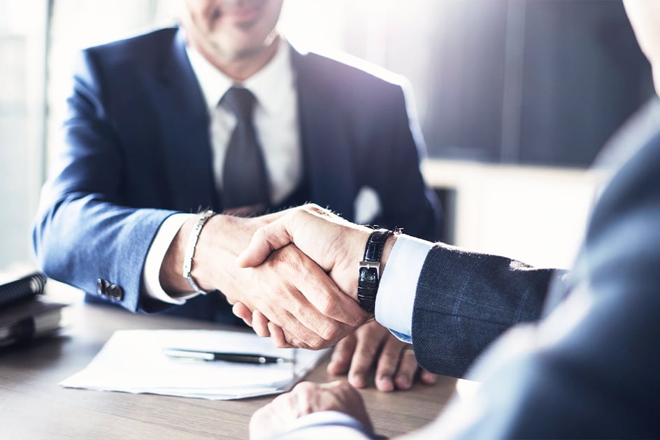 What do you need for a franchise loan | Two men shaking hands